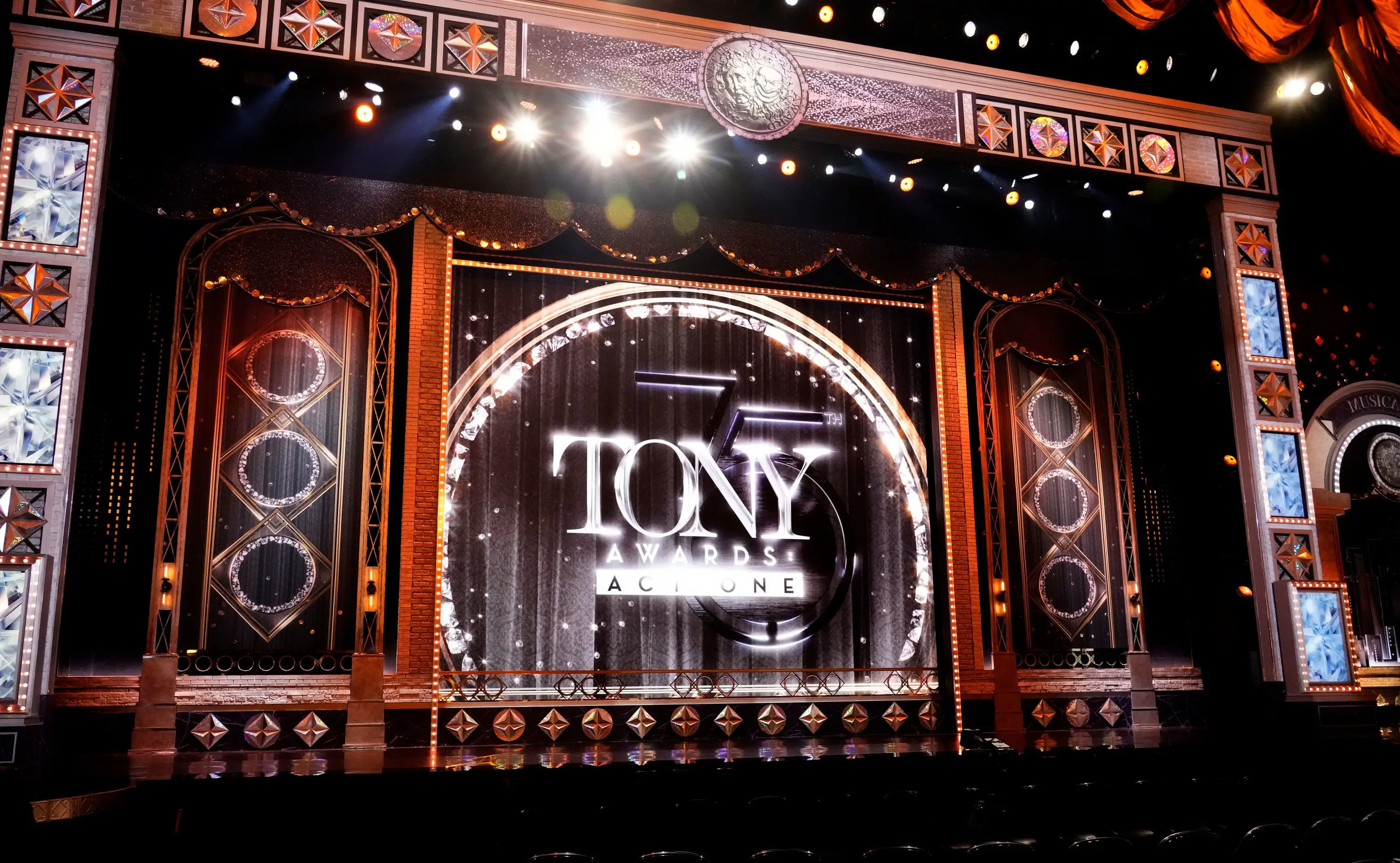 The Tony Awards stage framed by an ornate proscenium with the Tony emblem on the curtain